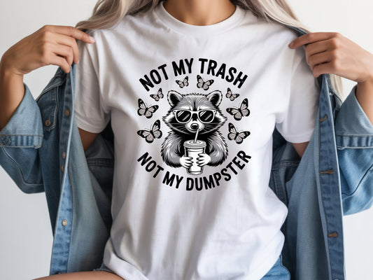 White raccoon shirt in oversized unisex fit featuring “Not My Trash Not My Dumpster” quote with a raccoon and butterflies.
