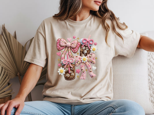 Woman wearing beige iced coffee t shirt with faux yarn style bow design