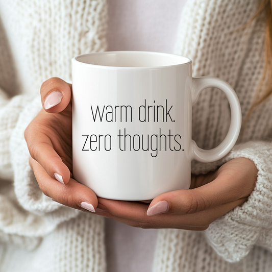 White mug with 'warm drink. zero thoughts' text.