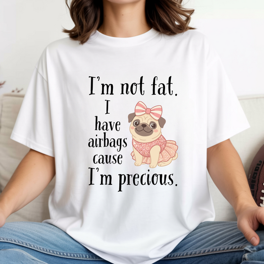 Woman wearing white funny graphic tee featuring the “I’m Not Fat, I Have Airbags Cause I’m Precious” quote.