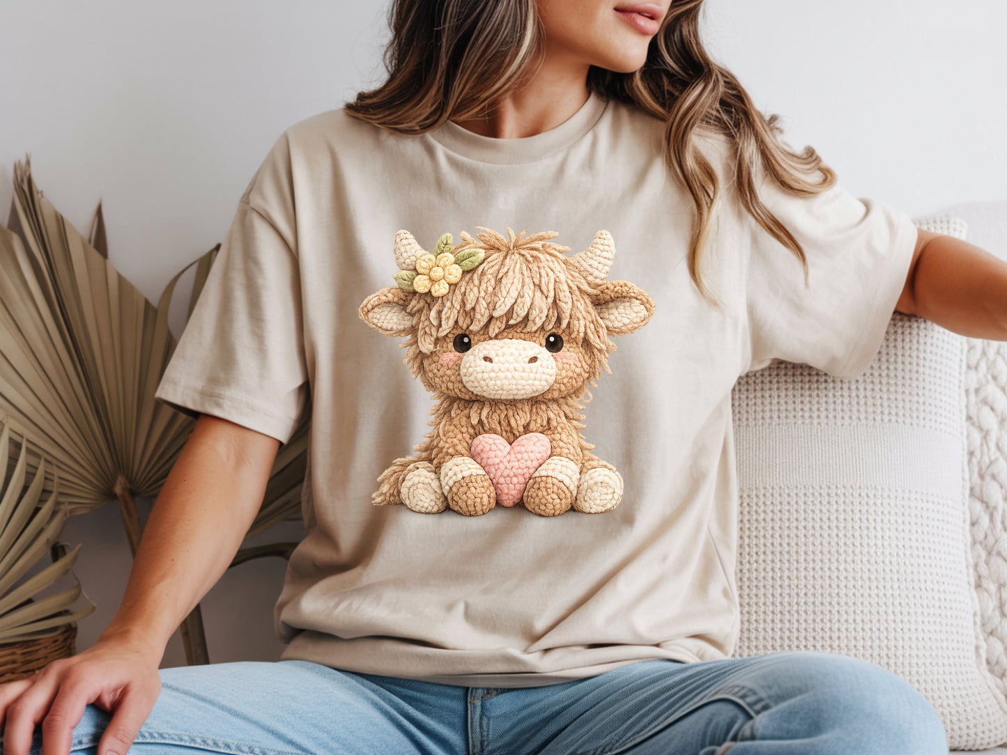Woman wearing beige highland cow t shirt with cute cow heart graphic