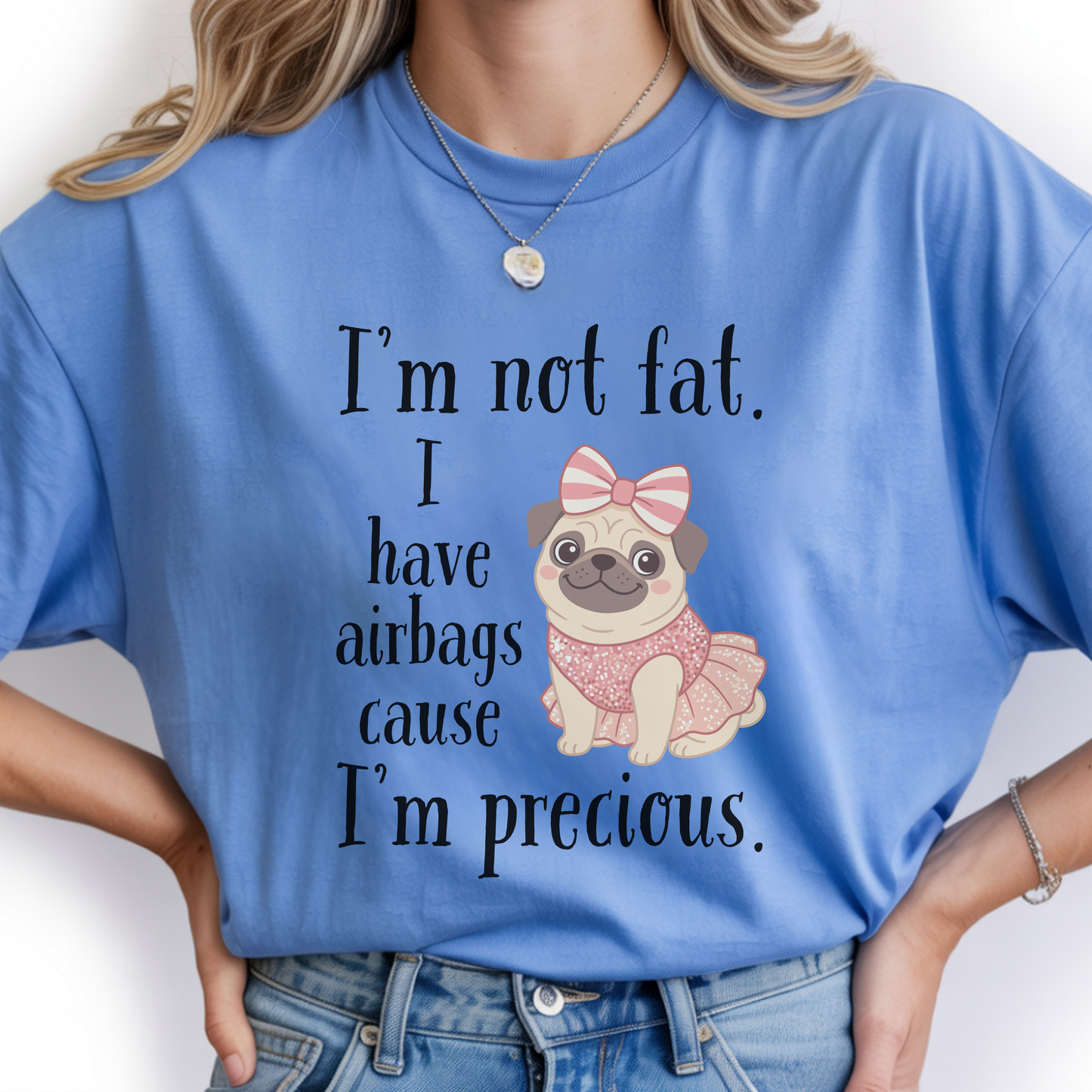 Woman wearing blue funny graphic tee featuring the “I’m Not Fat, I Have Airbags Cause I’m Precious” quote.