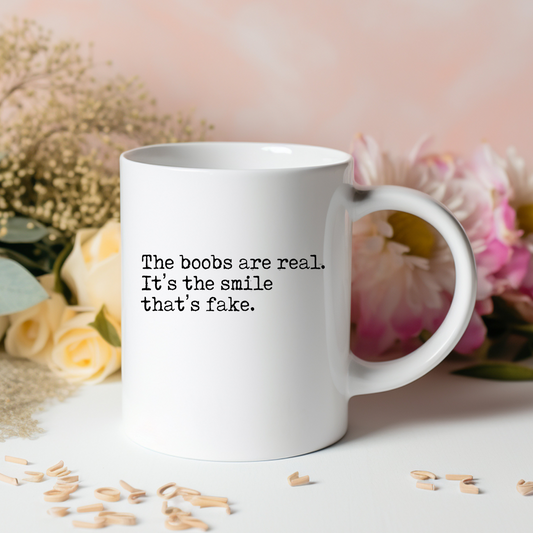 'The Boobs Are Real The Smile Is Fake Mug' White