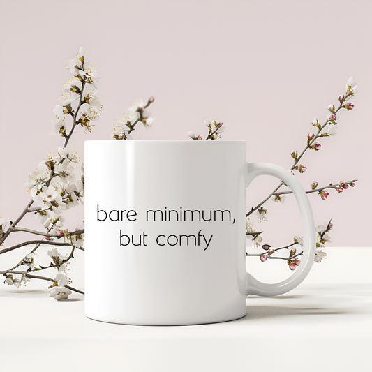 Cute mug that is white with 'bare minimum, but comfy' text on the front.