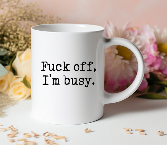 Fuck off mug that is white with "fuck off, I'm busy" text.