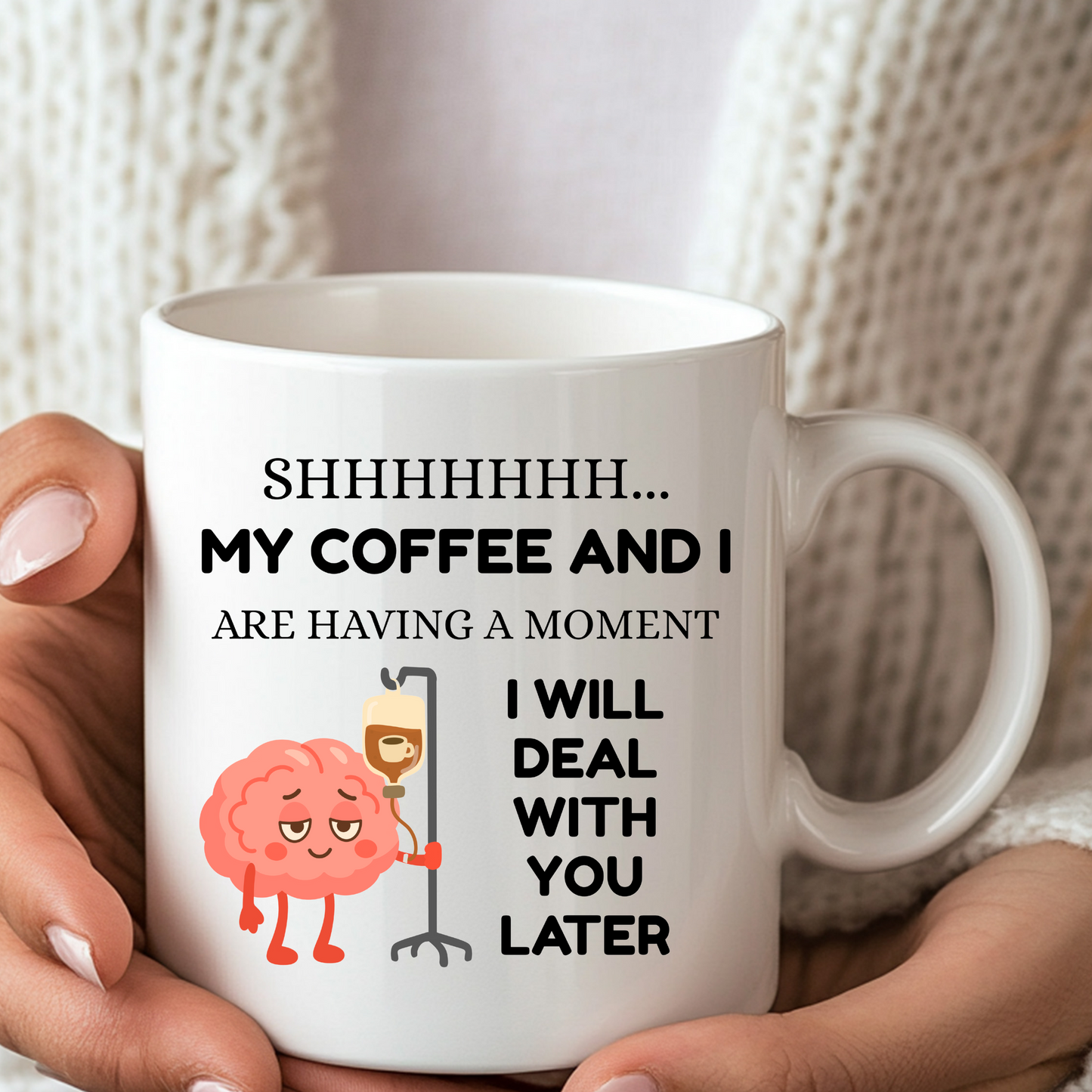 A white funny coffee lover mug with "shhhh my coffee and I are having a moment, I will deal with you later" text and a cute graphic of a brain holding an IV pole with coffee going in the IV.