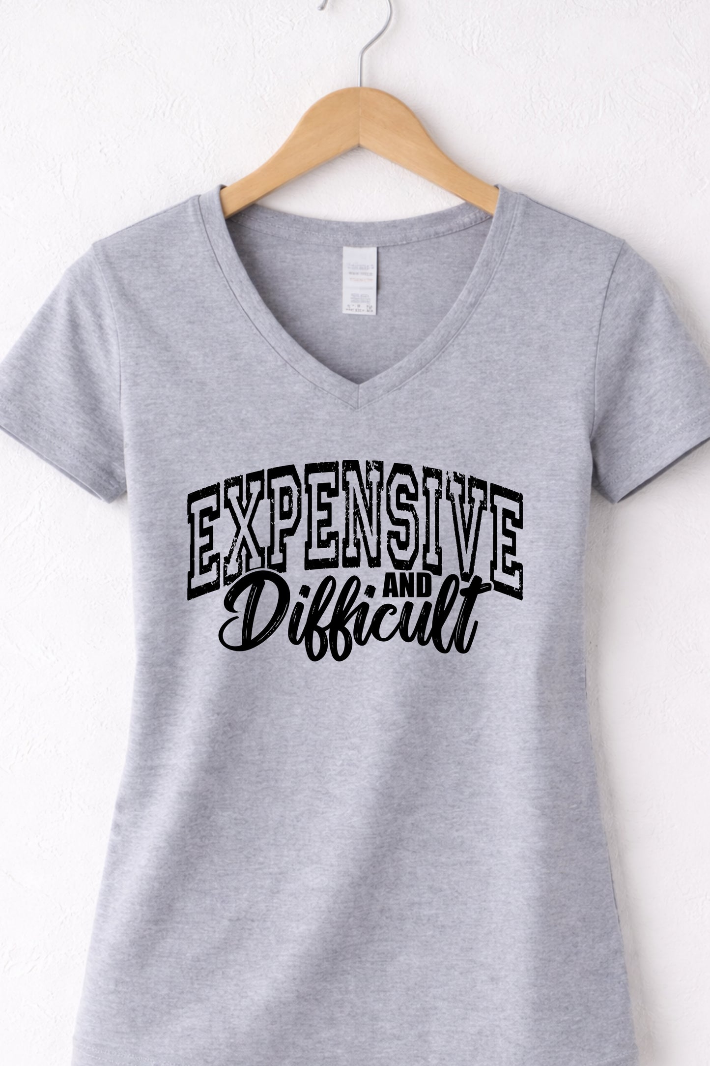 Grey women’s v neck expensive and difficult shirt featuring modern sassy statement design