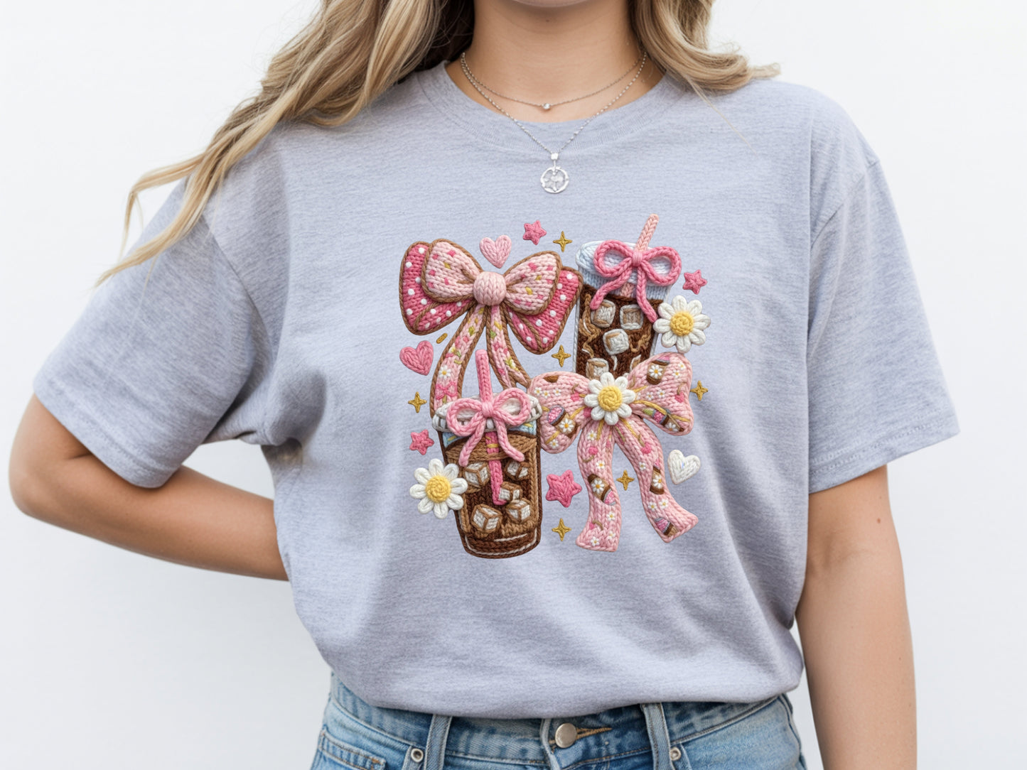 Woman wearing grey iced coffee t shirt with faux yarn style bow design