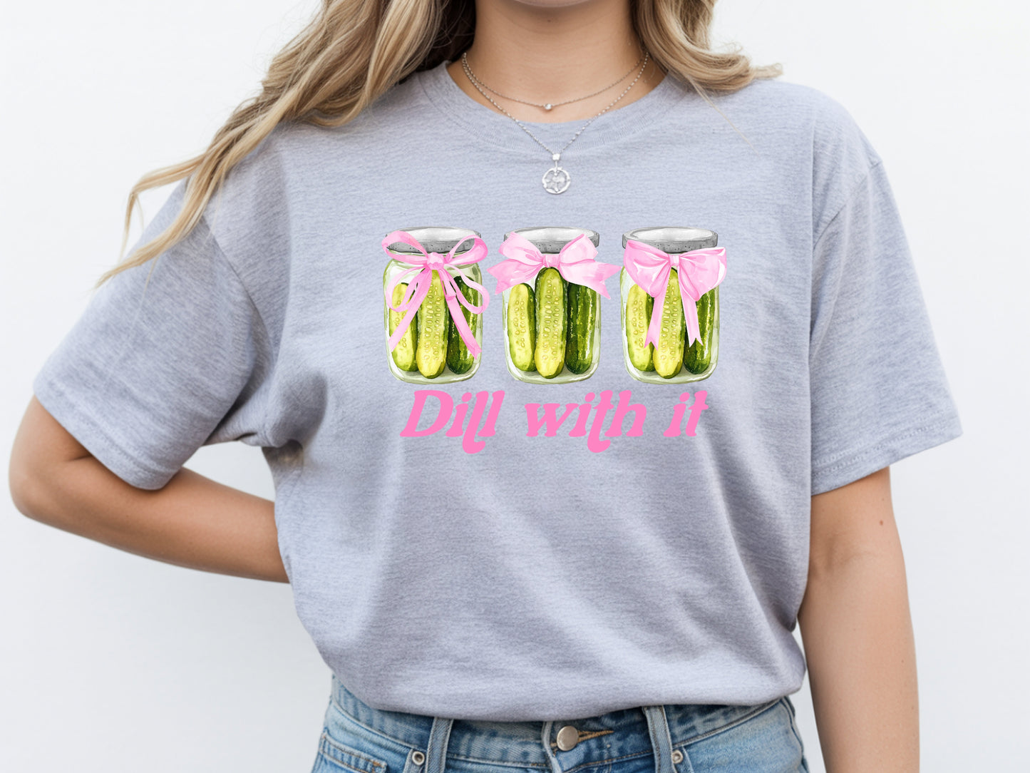 Person wearing grey unisex pickle t shirt with “Dill With It” quote and cute pickle jar design