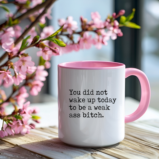 Inspirational mug with a pink handle/interior and a "you did not wake up to be a weak ass bitch" text.
