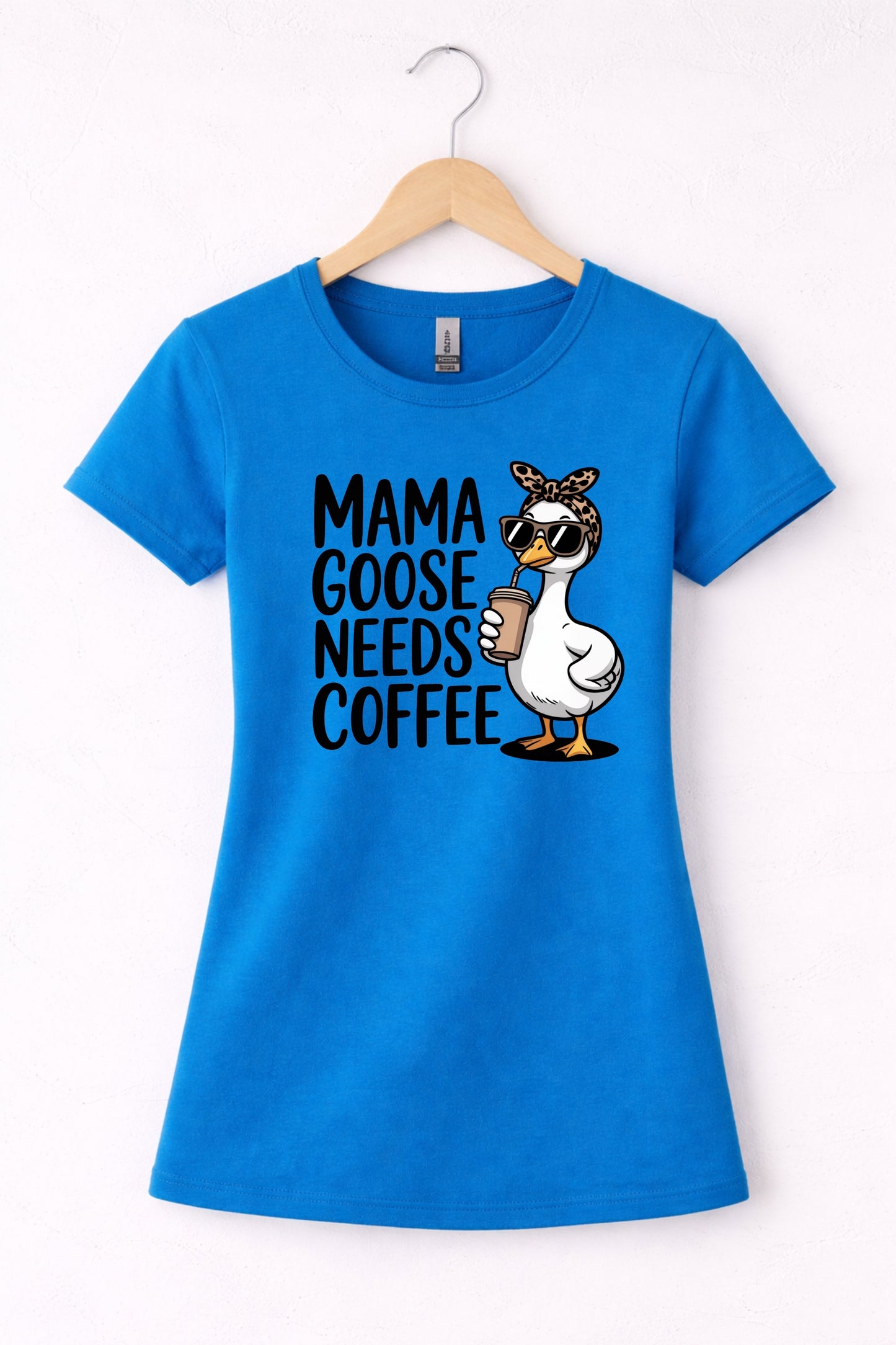 Mama needs coffee shirt with cute "Mama goose needs coffee" text and goose graphic on a blue women's crewneck shirt.