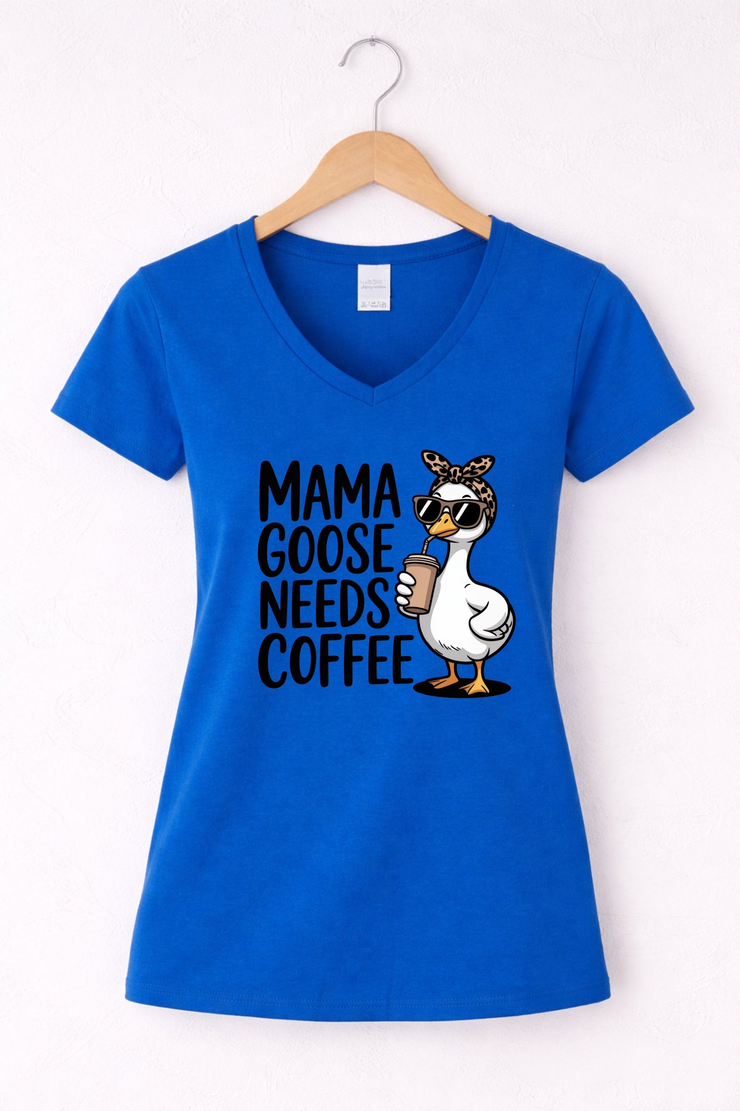 Mama needs coffee shirt with cute "Mama goose needs coffee" text and goose graphic on a blue women's V-neck shirt.