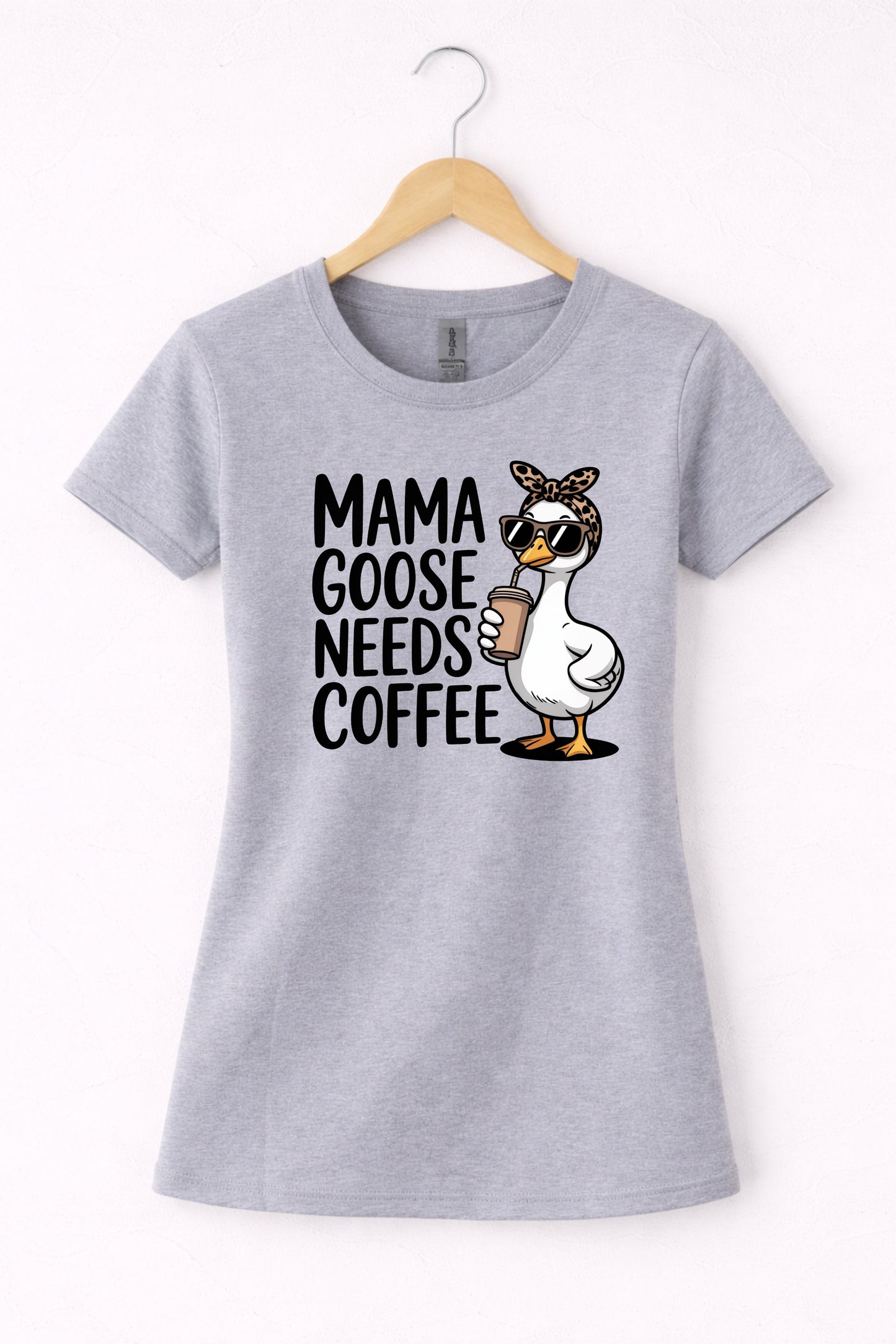 Mama needs coffee shirt with cute "Mama goose needs coffee" text and goose graphic on a grey women's crewneck shirt.