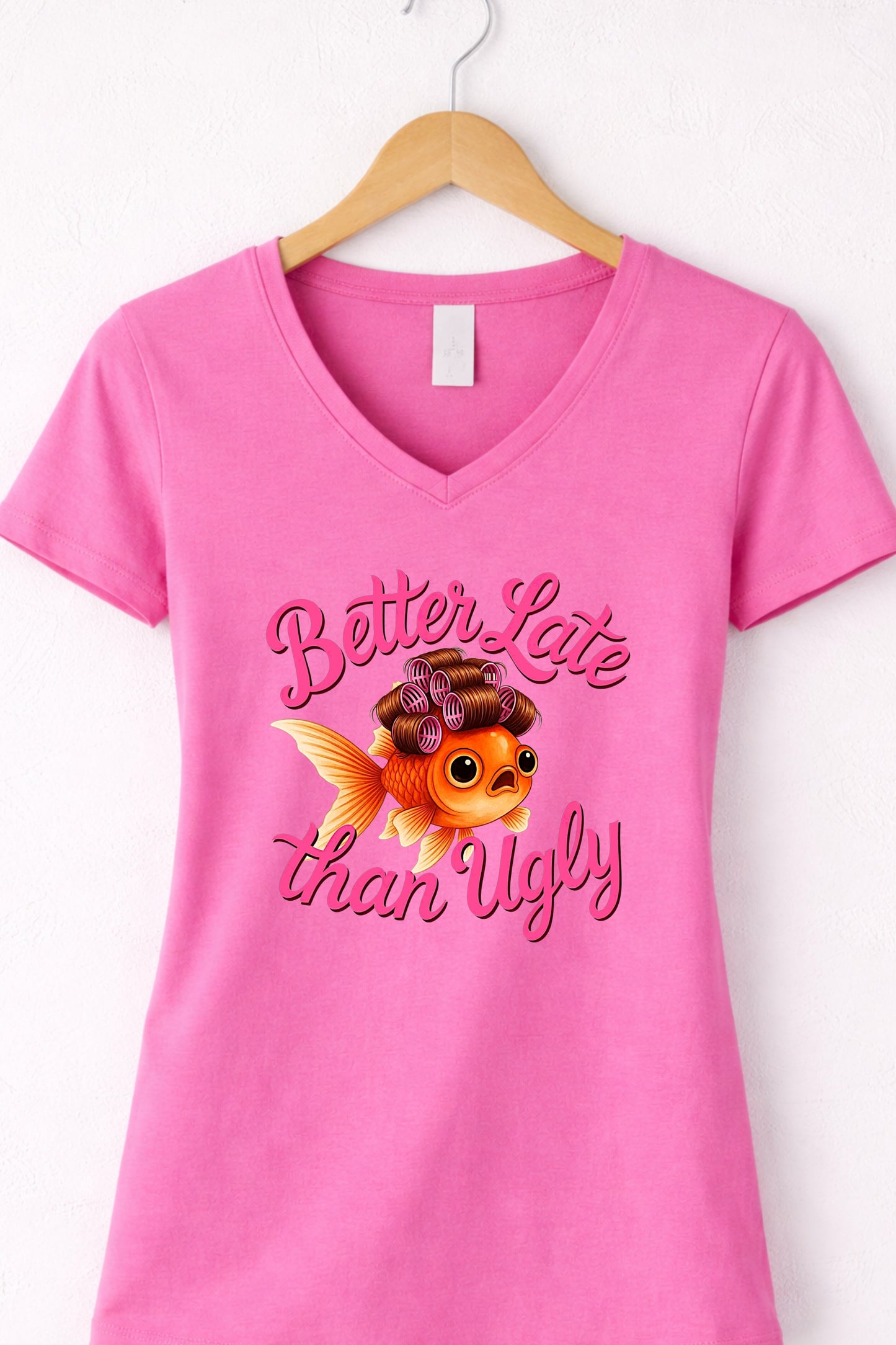 Pink women’s v neck cute fish t shirt featuring glam goldfish and “Better Late Than Ugly” saying