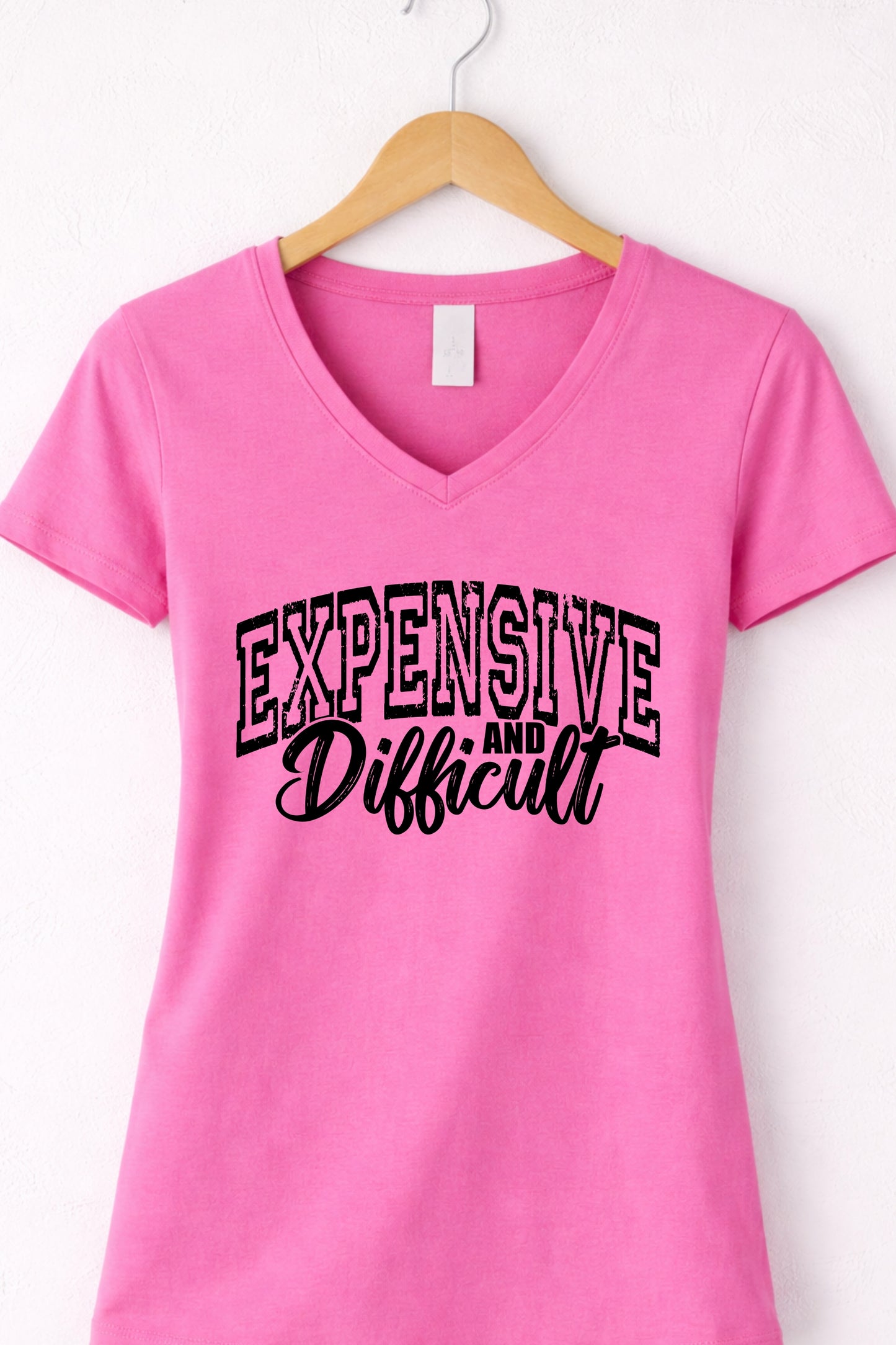 Pink women’s v neck expensive and difficult shirt featuring modern sassy statement design