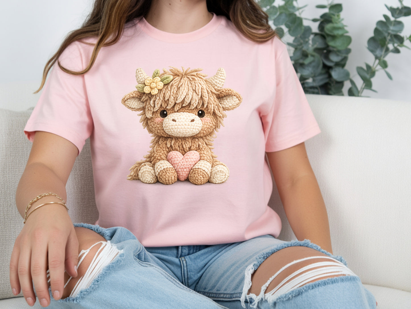 Woman wearing pink highland cow t shirt with cute cow heart graphic