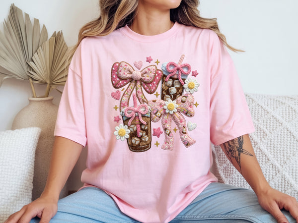 Woman wearing pink iced coffee t shirt with faux yarn style bow design