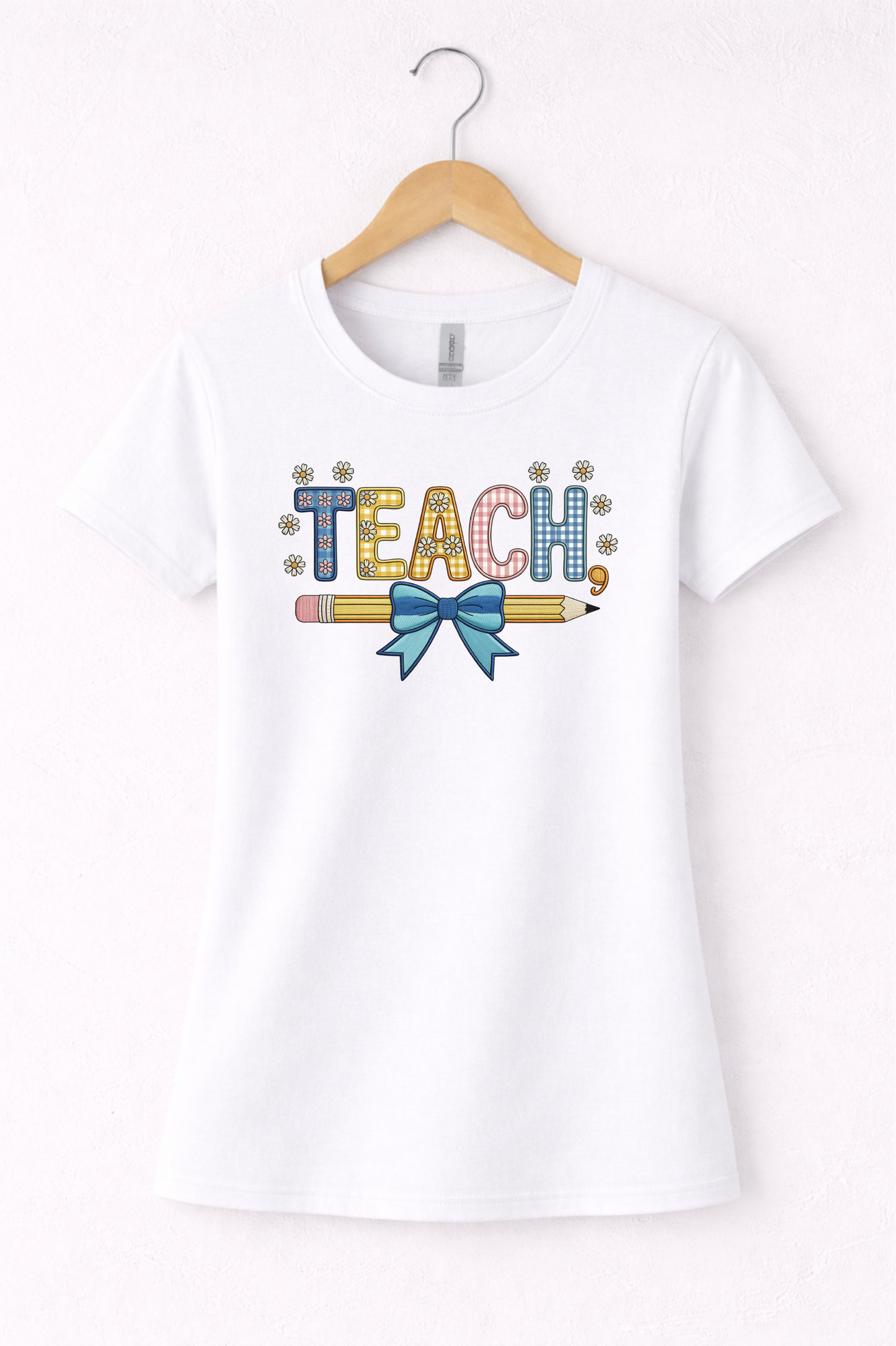 Teacher shirt for women with a cute pencil with blue bow graphic and "Teach" text on a white women's crewneck tshirt. 