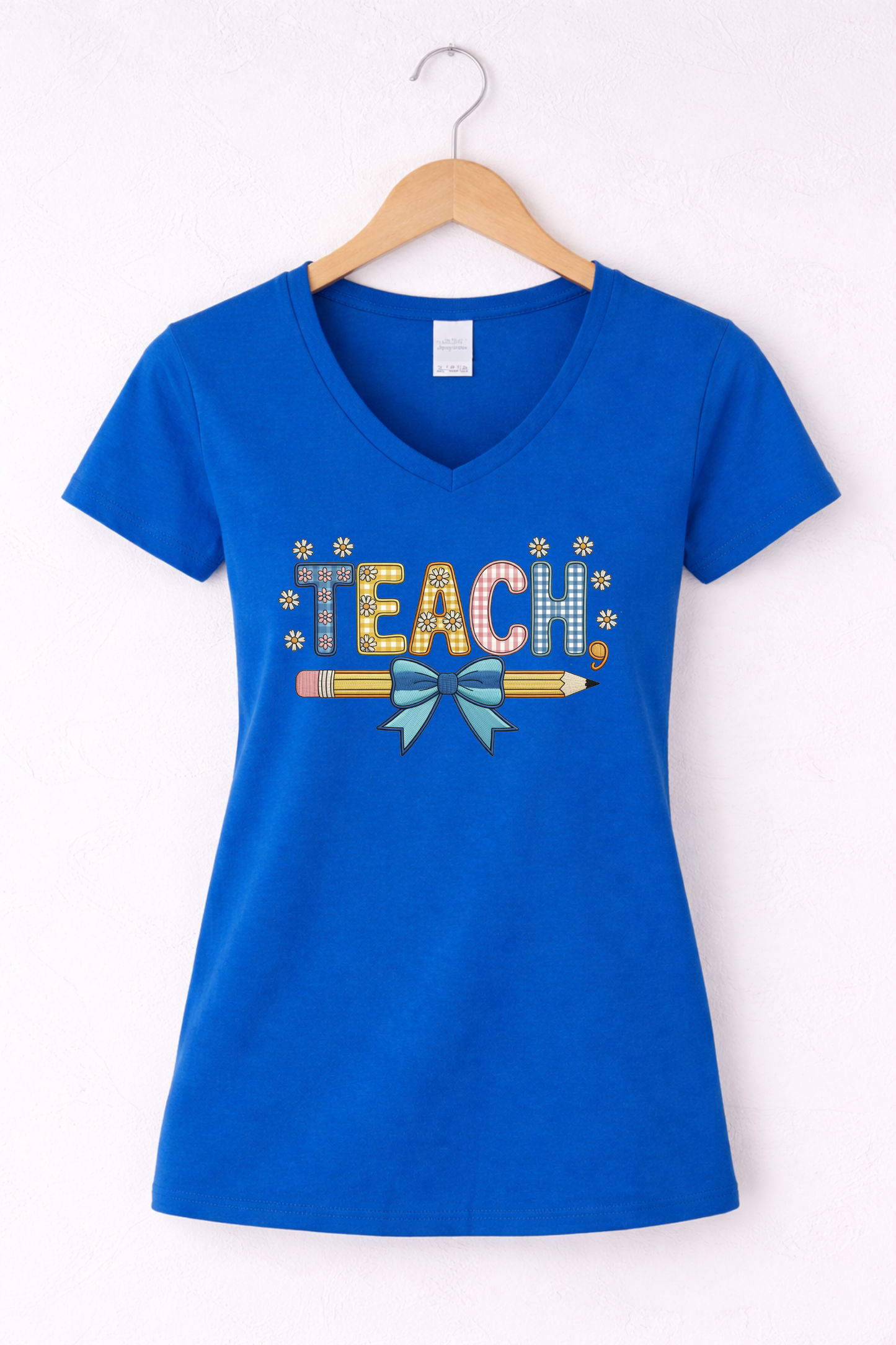 Teacher shirt for women with a cute pencil with blue bow graphic and "Teach" text on a blue women's v-neck tshirt. 