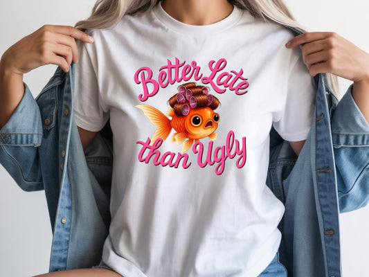 Person wearing white unisex cute fish t shirt with “Better Late Than Ugly” sarcastic quote and glam goldfish design