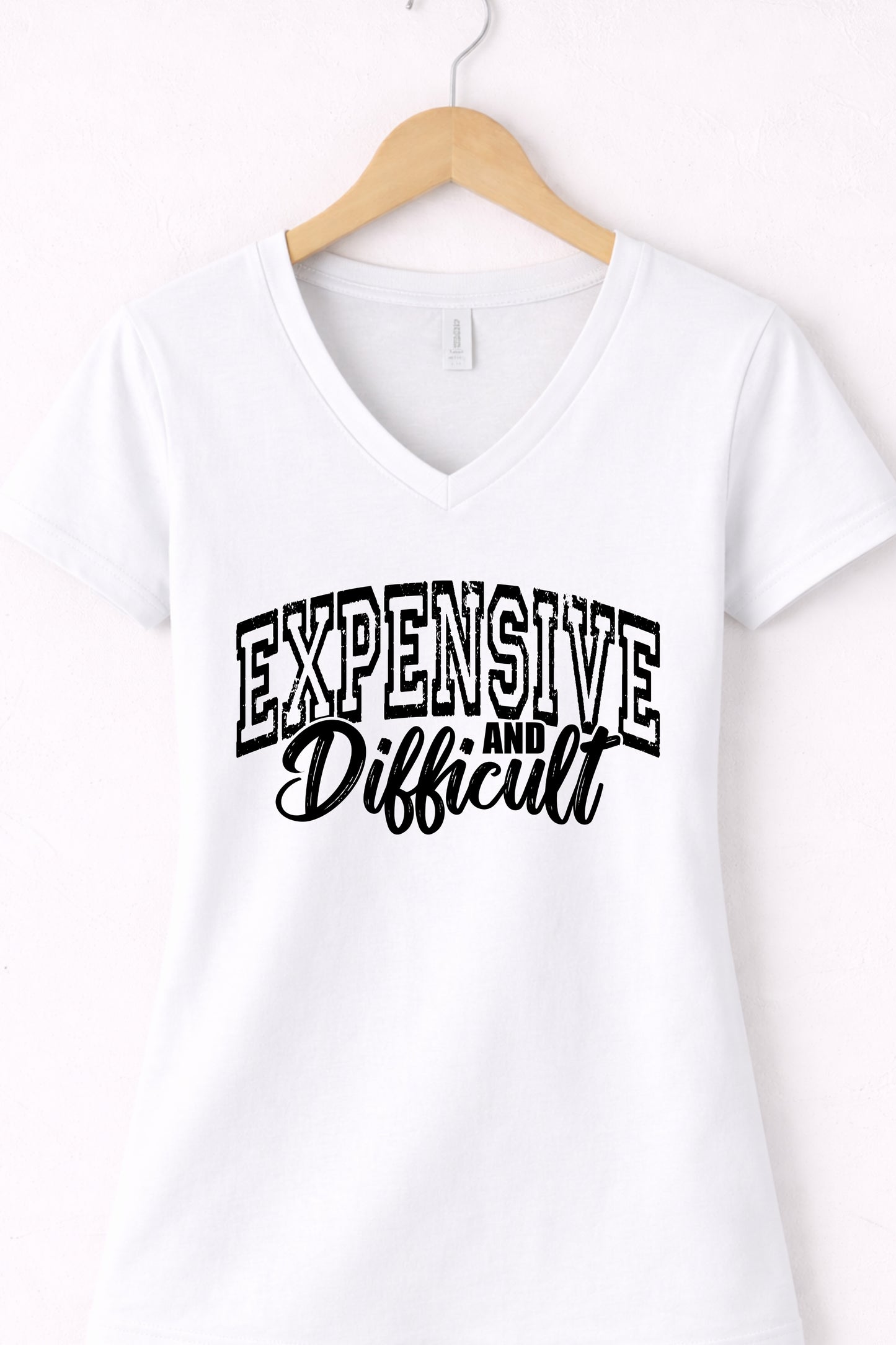 White women’s v neck expensive and difficult shirt featuring modern sassy statement design