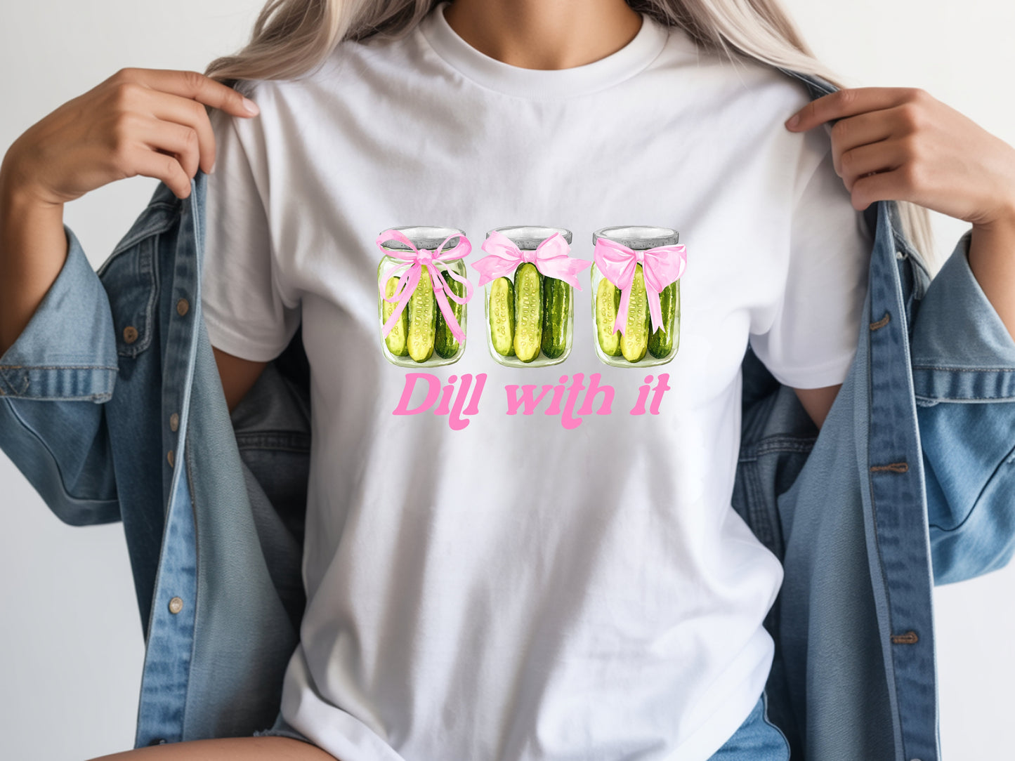 Person wearing white unisex pickle t shirt with “Dill With It” quote and cute pickle jar design