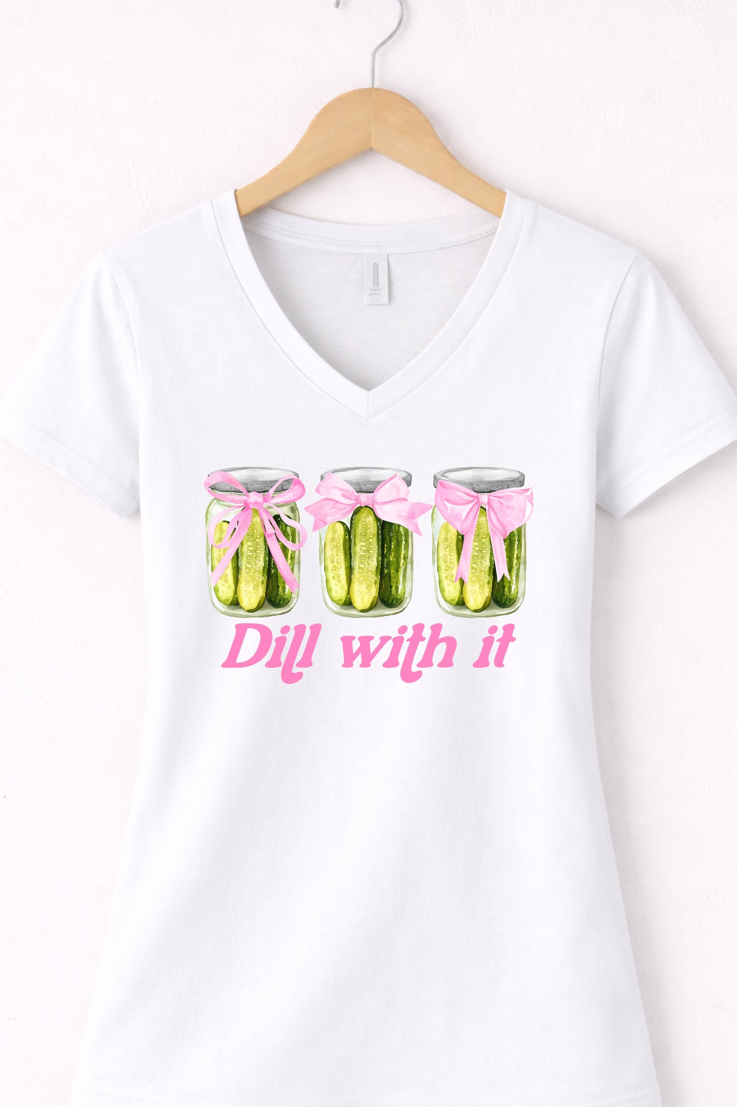 White women’s v neck pickle t shirt featuring trendy pickle lover “Dill With It” design